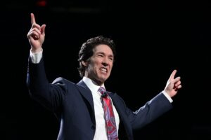 Joel Osteen on stage preaching in a past sunday service