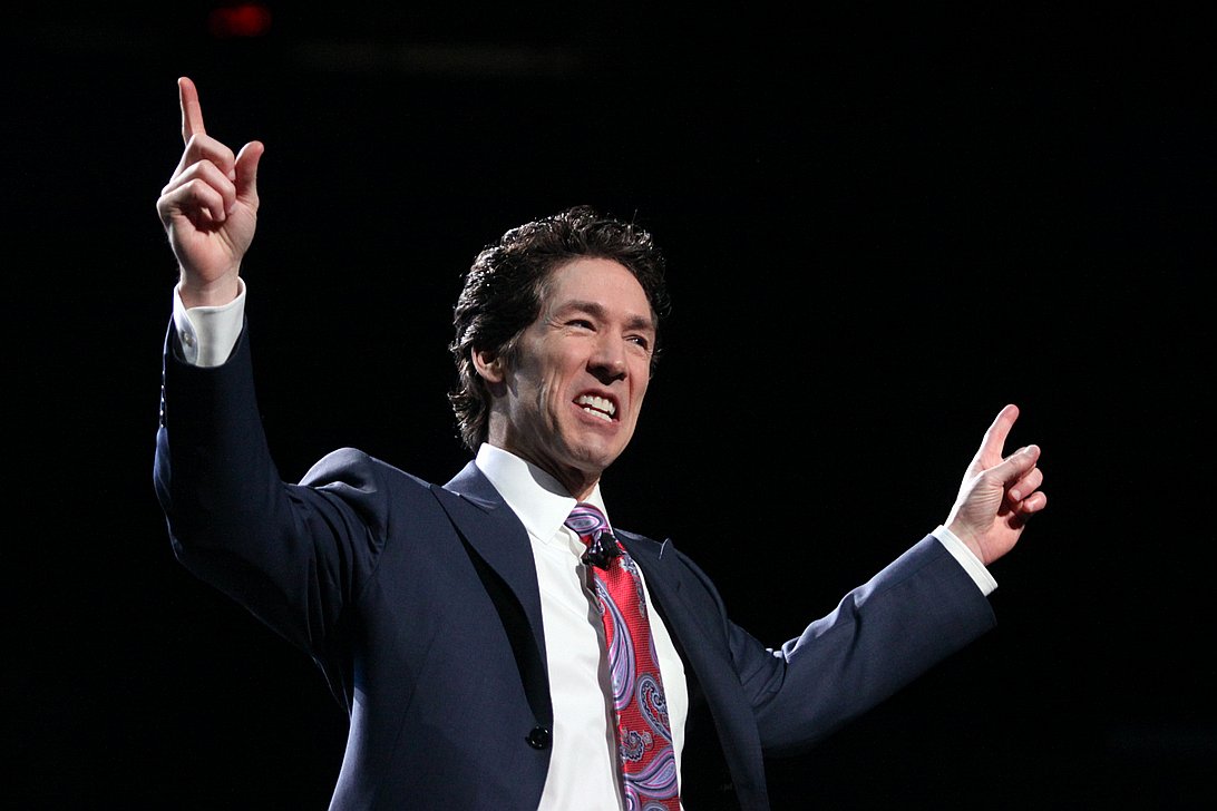 Joel Osteen on stage preaching in a past sunday service